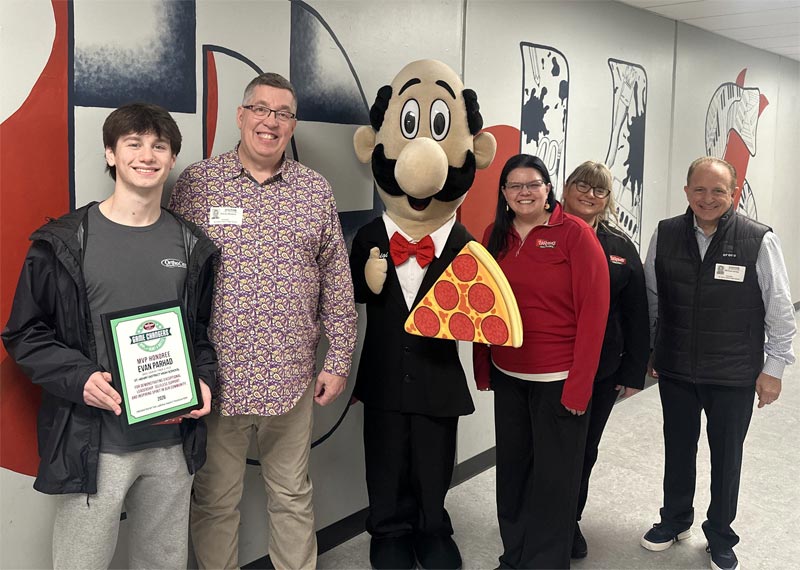 EVAN PARHAD being handed a plaque